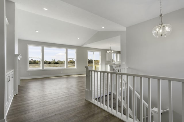 9423 Shoreway Dr, West Olive, MI 49460 - hall with a chandelier, dark wood-style floors, lofted ceiling, recessed lighting, and an upstairs landing