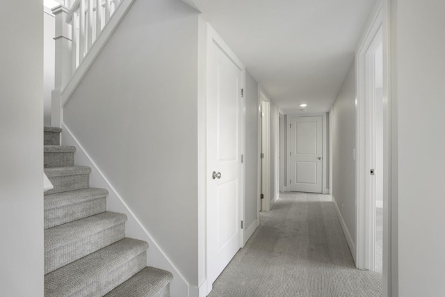 9423 Shoreway Dr, West Olive, MI 49460 - hallway with carpet flooring, stairs, and baseboards