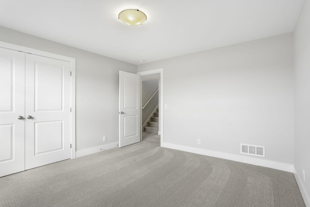 9423 Shoreway Dr, West Olive, MI 49460 - unfurnished bedroom with carpet floors, baseboards, and a closet