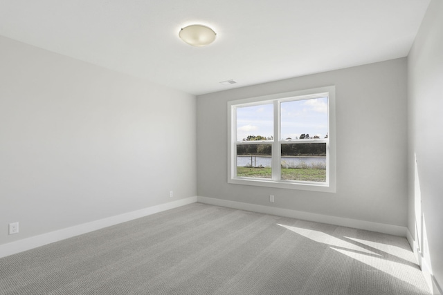 9423 Shoreway Dr, West Olive, MI 49460 - unfurnished room with light colored carpet and baseboards