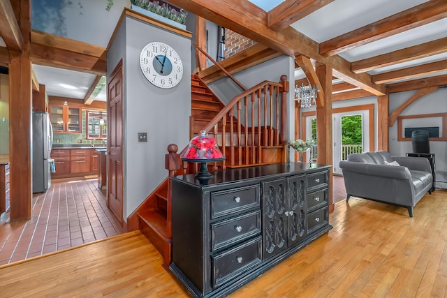 70191 Carolyn Ave, Sturgis, MI 49091 - hall featuring stairway, light wood-style flooring, a chandelier, and beamed ceiling