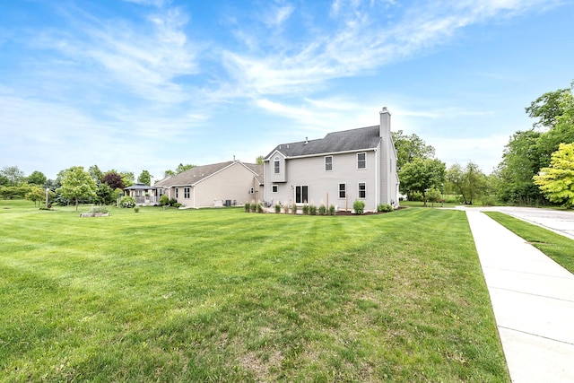 6837 Wellington Dr, Dexter, MI 48130 - view of side of property featuring a yard and a chimney