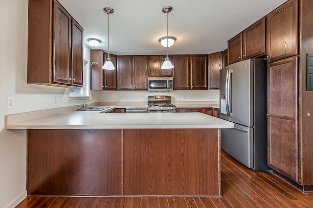 6837 Wellington Dr, Dexter, MI 48130 - kitchen featuring appliances with stainless steel finishes, a sink, dark wood-style floors, dark brown cabinets, and light countertops