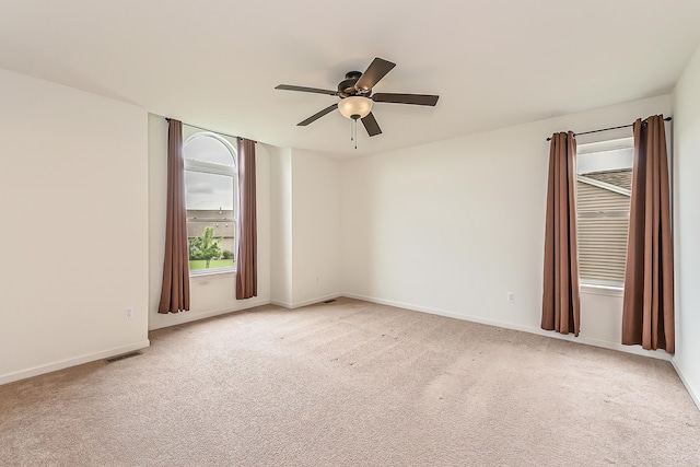 6837 Wellington Dr, Dexter, MI 48130 - spare room featuring ceiling fan, light colored carpet, and baseboards