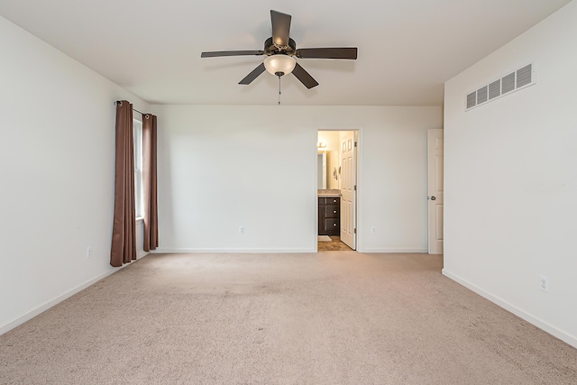 6837 Wellington Dr, Dexter, MI 48130 - empty room featuring a ceiling fan, light colored carpet, and baseboards