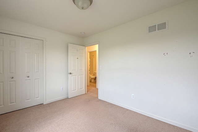 6837 Wellington Dr, Dexter, MI 48130 - unfurnished bedroom featuring light colored carpet, baseboards, and a closet