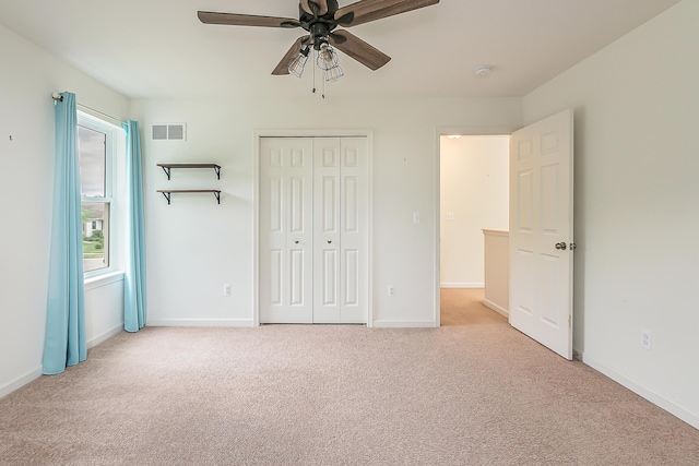 6837 Wellington Dr, Dexter, MI 48130 - unfurnished bedroom with carpet floors, a closet, baseboards, and a ceiling fan