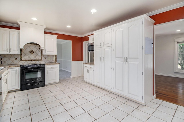 2314 Hickory Point Dr N, Portage, MI 49024 - kitchen with black electric range oven, stainless steel microwave, crown molding, white cabinetry, and tasteful backsplash