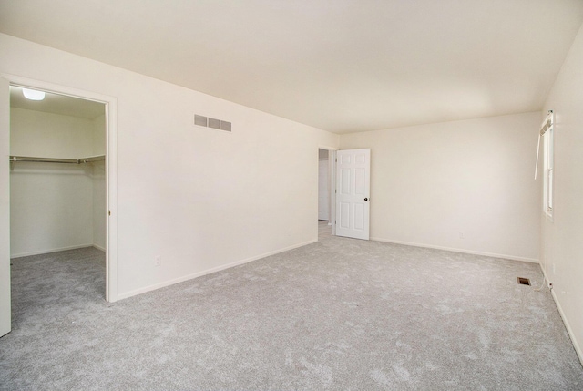2314 Hickory Point Dr N, Portage, MI 49024 - unfurnished bedroom featuring carpet floors, a walk in closet, and baseboards