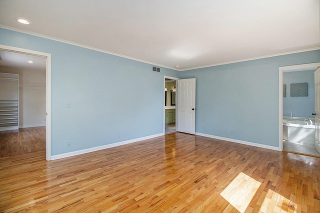 2314 Hickory Point Dr N, Portage, MI 49024 - spare room with crown molding, wood finished floors, baseboards, and recessed lighting