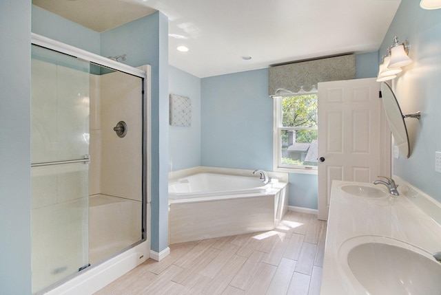 2314 Hickory Point Dr N, Portage, MI 49024 - bathroom featuring a stall shower, a bath, double vanity, baseboards, and wood tiled floors