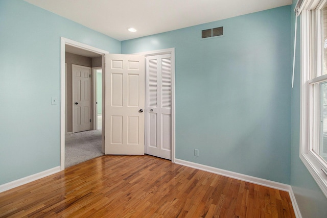 2314 Hickory Point Dr N, Portage, MI 49024 - unfurnished bedroom featuring baseboards, light wood-style floors, and a closet