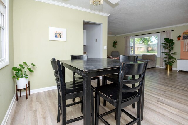 9017 N Main St, Berrien Springs, MI 49103 - dining space with light wood-type flooring, baseboards, and ornamental molding