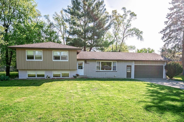 9017 N Main St, Berrien Springs, MI 49103 - tri-level home featuring an attached garage, concrete driveway, a front yard, and brick siding