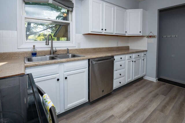 9017 N Main St, Berrien Springs, MI 49103 - kitchen with stainless steel dishwasher, a sink, white cabinetry, backsplash, and wood finished floors