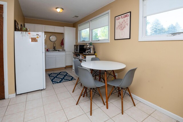 9017 N Main St, Berrien Springs, MI 49103 - dining space with light tile patterned floors and baseboards