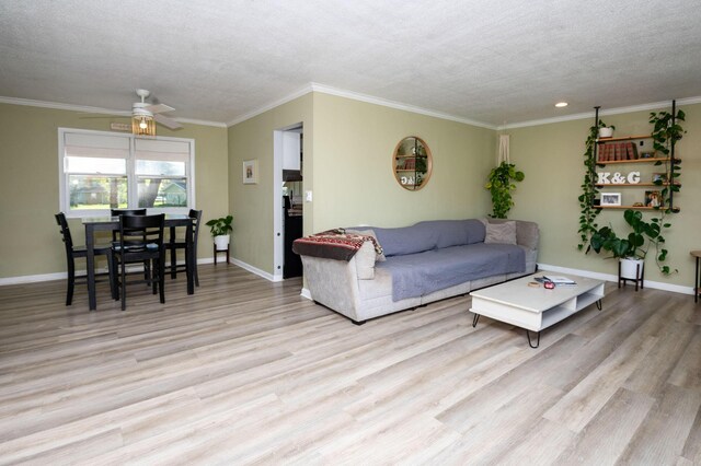 9017 N Main St, Berrien Springs, MI 49103 - living area featuring a ceiling fan, a textured ceiling, wood finished floors, baseboards, and crown molding