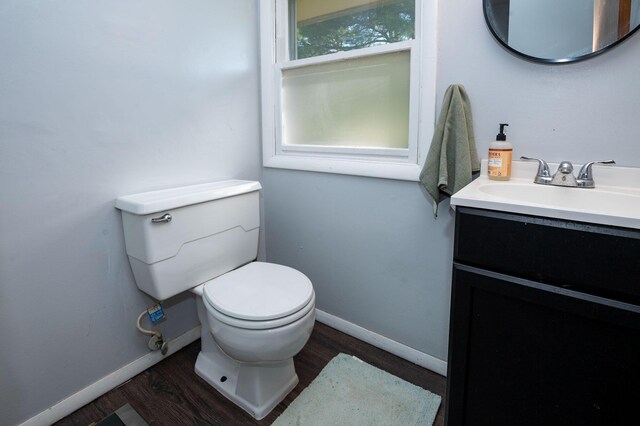 9017 N Main St, Berrien Springs, MI 49103 - bathroom featuring wood finished floors, baseboards, toilet, and vanity