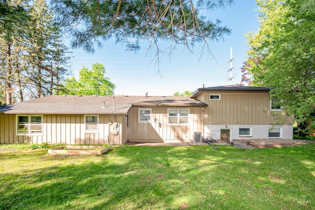 9017 N Main St, Berrien Springs, MI 49103 - rear view of house with central air condition unit, a yard, and board and batten siding