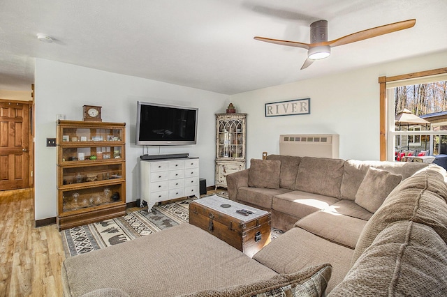 3897 N Chief Pontiac Trl, Branch, MI 49402 - living area featuring wood finished floors, ceiling fan, and baseboards