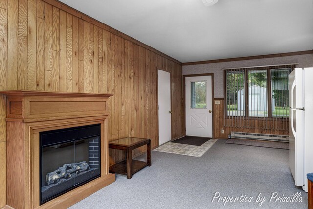 315 Hayes St NW, Comstock Park, MI 49321 - unfurnished living room featuring a baseboard radiator, wooden walls, a glass covered fireplace, carpet flooring, and crown molding
