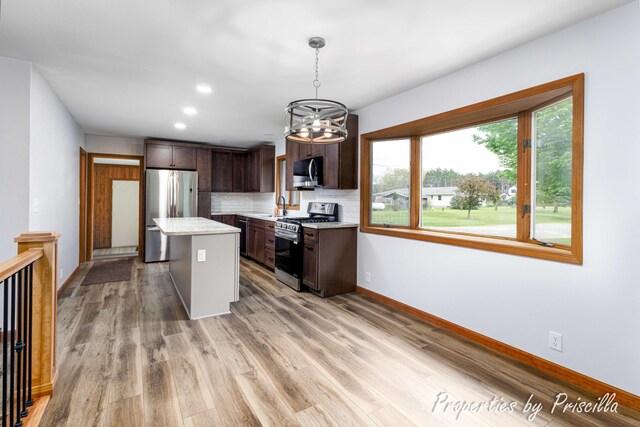 315 Hayes St NW, Comstock Park, MI 49321 - kitchen with stainless steel appliances, a sink, light countertops, dark brown cabinetry, and recessed lighting
