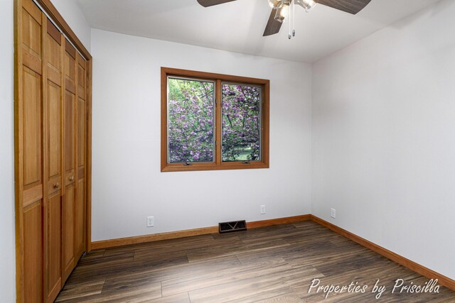 315 Hayes St NW, Comstock Park, MI 49321 - unfurnished bedroom with dark wood finished floors, baseboards, a closet, and ceiling fan