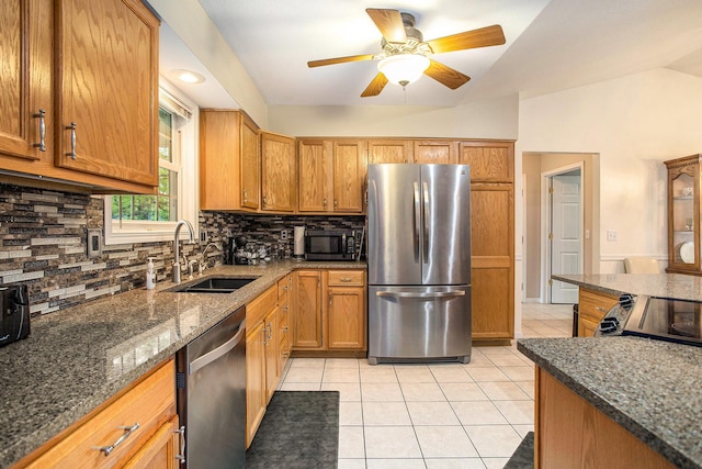 232 Embury Dr, Battle Creek, MI 49014 - kitchen featuring stainless steel appliances, a sink, light tile patterned floors, lofted ceiling, and a ceiling fan