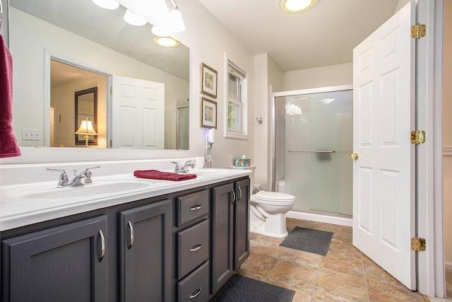 232 Embury Dr, Battle Creek, MI 49014 - bathroom with a stall shower, double vanity, toilet, and stone finish floors
