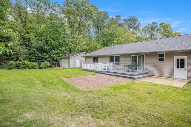 232 Embury Dr, Battle Creek, MI 49014 - view of yard with a wooden deck, a garage, a patio area, and an outbuilding