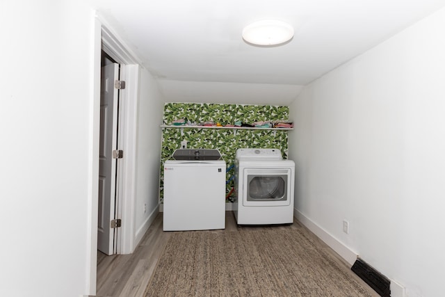 104 S Lowe St, Dowagiac, MI 49047 - laundry area with washer and clothes dryer, light wood finished floors, and baseboards