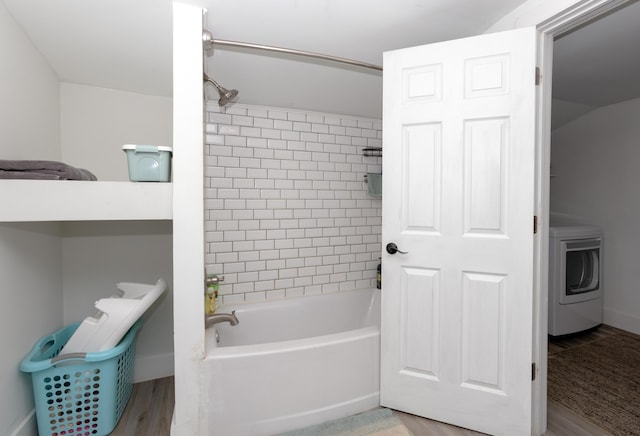 104 S Lowe St, Dowagiac, MI 49047 - bathroom featuring washer / dryer, shower / bath combination, wood finished floors, and baseboards