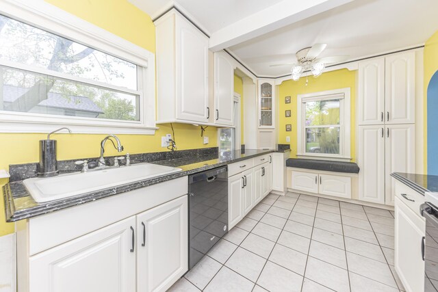 885 Hawthorne Ave, Ypsilanti, MI 48198 - kitchen with black dishwasher, a sink, light tile patterned floors, and white cabinets