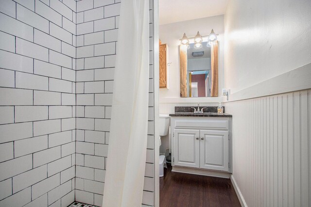 32867 Middle Crossing Rd, Dowagiac, MI 49047 - bathroom with vanity, a tile shower, toilet, and wood finished floors