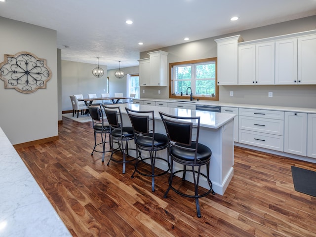 1518 M Dr S, East Leroy, MI 49051 - kitchen featuring a kitchen breakfast bar, light countertops, a center island, white cabinets, and recessed lighting