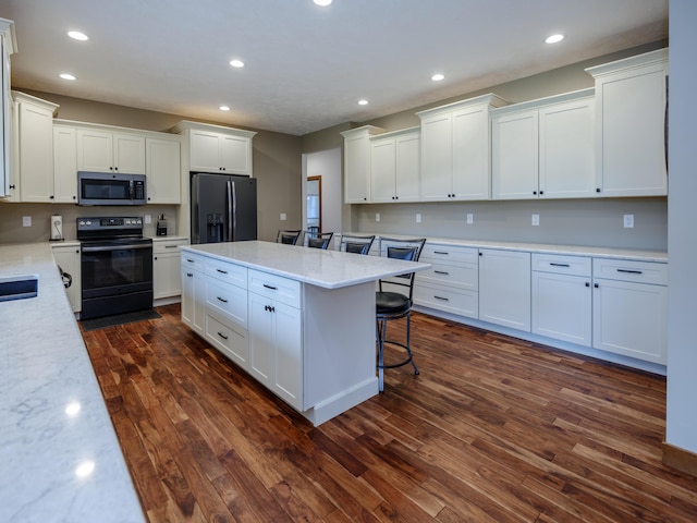 1518 M Dr S, East Leroy, MI 49051 - kitchen featuring black appliances, white cabinets, dark wood-style flooring, a center island, and recessed lighting