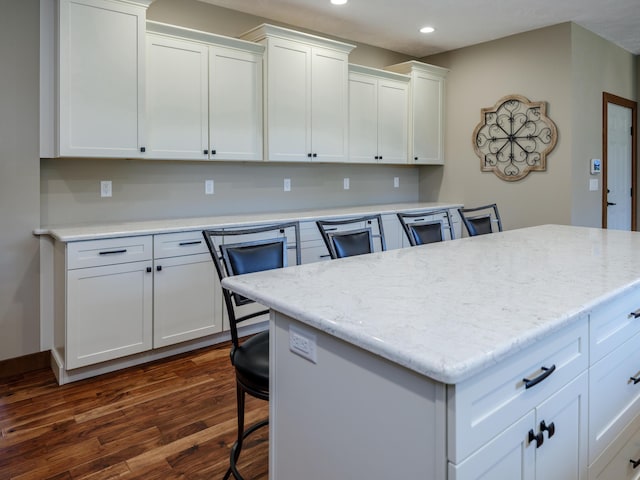 1518 M Dr S, East Leroy, MI 49051 - kitchen featuring recessed lighting, dark wood finished floors, white cabinets, a center island, and a breakfast bar area