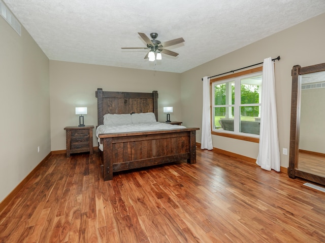 1518 M Dr S, East Leroy, MI 49051 - bedroom with wood finished floors, a textured ceiling, and a ceiling fan