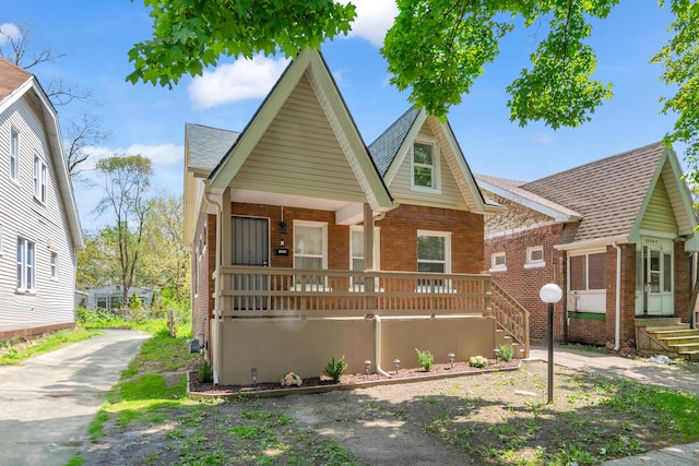 16568 Monica St, Detroit, MI 48221 - view of front of property with brick siding, covered porch, and a shingled roof