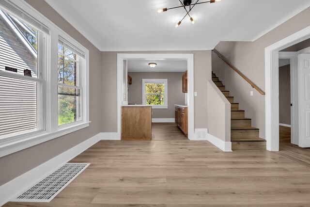 16568 Monica St, Detroit, MI 48221 - foyer entrance with a chandelier, stairway, baseboards, and light wood-style floors