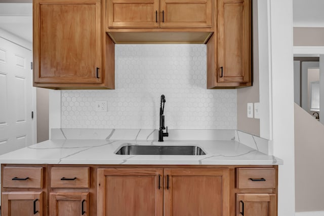 16568 Monica St, Detroit, MI 48221 - kitchen with a sink, backsplash, light stone counters, and brown cabinets