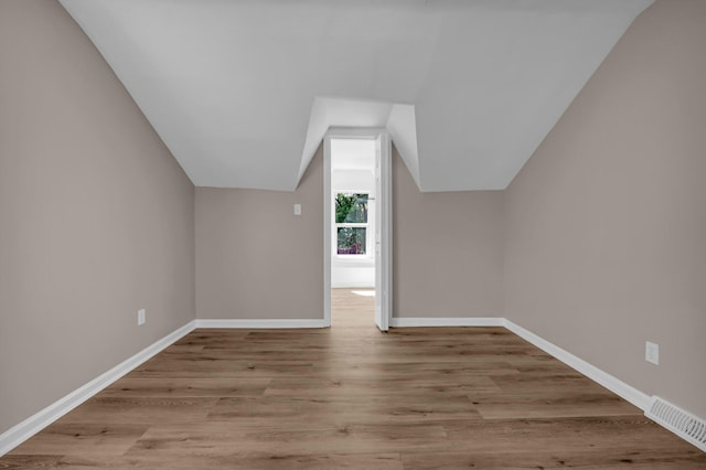 16568 Monica St, Detroit, MI 48221 - bonus room with wood finished floors, vaulted ceiling, and baseboards