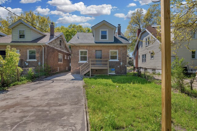 16568 Monica St, Detroit, MI 48221 - bungalow-style home with a chimney, brick siding, and concrete driveway