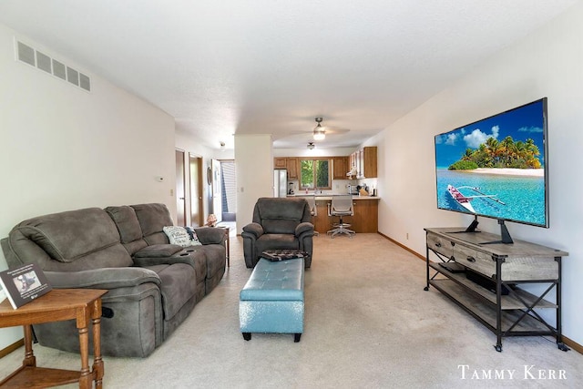 940 Laketown Dr, Holland, MI 49423 - living area featuring light carpet, a ceiling fan, and baseboards