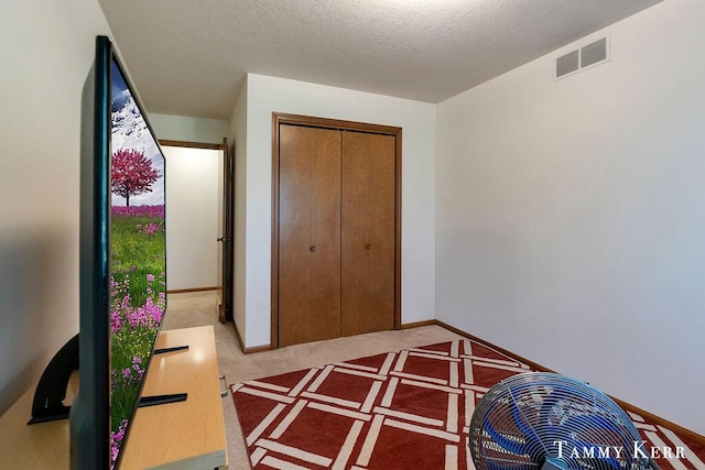 940 Laketown Dr, Holland, MI 49423 - carpeted bedroom with a closet, a textured ceiling, and baseboards