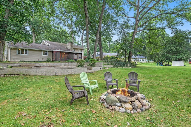 1514 Ferndale Blvd, Niles, MI 49120 - view of grassy yard with an outdoor fire pit and a sunroom
