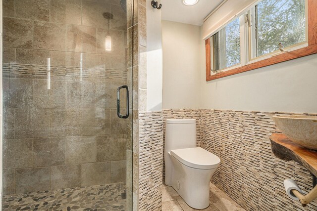 1514 Ferndale Blvd, Niles, MI 49120 - bathroom with tile walls, a stall shower, tile patterned flooring, toilet, and a wainscoted wall