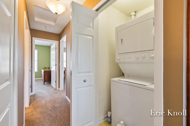 4865 Rapid River Ave SW, Wyoming, MI 49418 - laundry area with stacked washer / dryer, light colored carpet, and baseboards