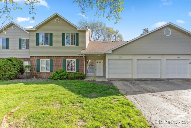 3185 Windcrest Dr NE, Grand Rapids, MI 49525 - view of front facade with brick siding, a front lawn, and driveway