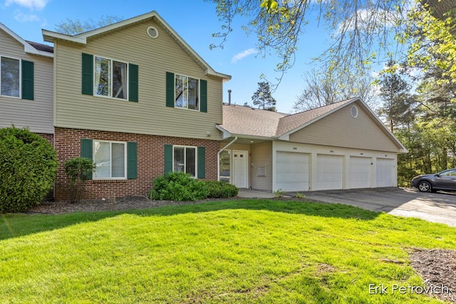 3185 Windcrest Dr NE, Grand Rapids, MI 49525 - view of front of home featuring an attached garage, driveway, brick siding, and a front yard